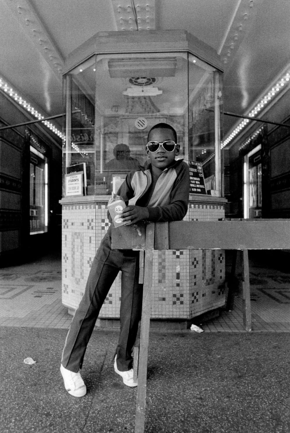 “Boy in front of Harlem movie theater 1976.”